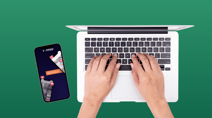 manos sobre el teclado de un macbook y tablet con logo YOPPEN